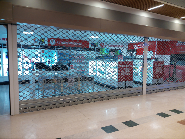 Grille et rideau métallique motorisé pour commerce